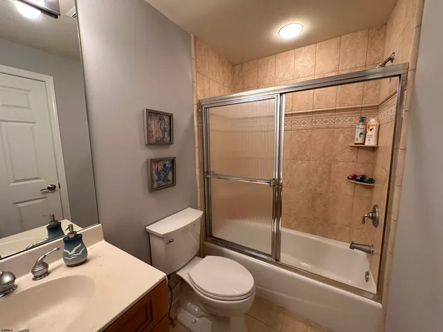 a white toilet sitting next to a bathroom sink