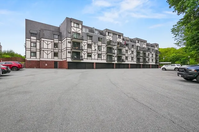 a front view of a building with parking space