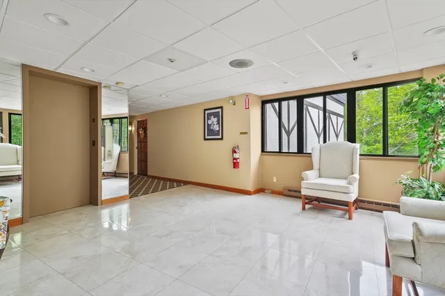 a living room with furniture and large window
