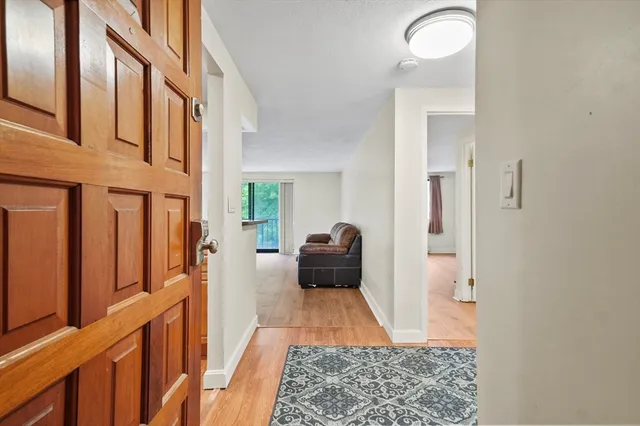 a view of an entryway with wooden floor