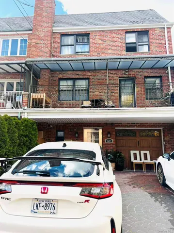 a view of building with car parked