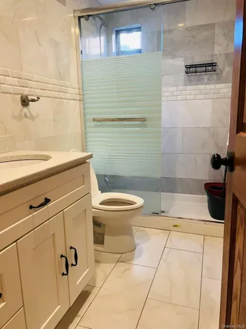 a bathroom with a toilet and a shower