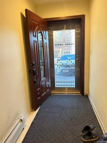 a view of an empty room with a fireplace and a window