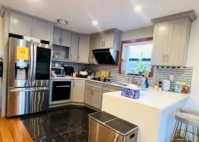 a kitchen with refrigerator and cabinets