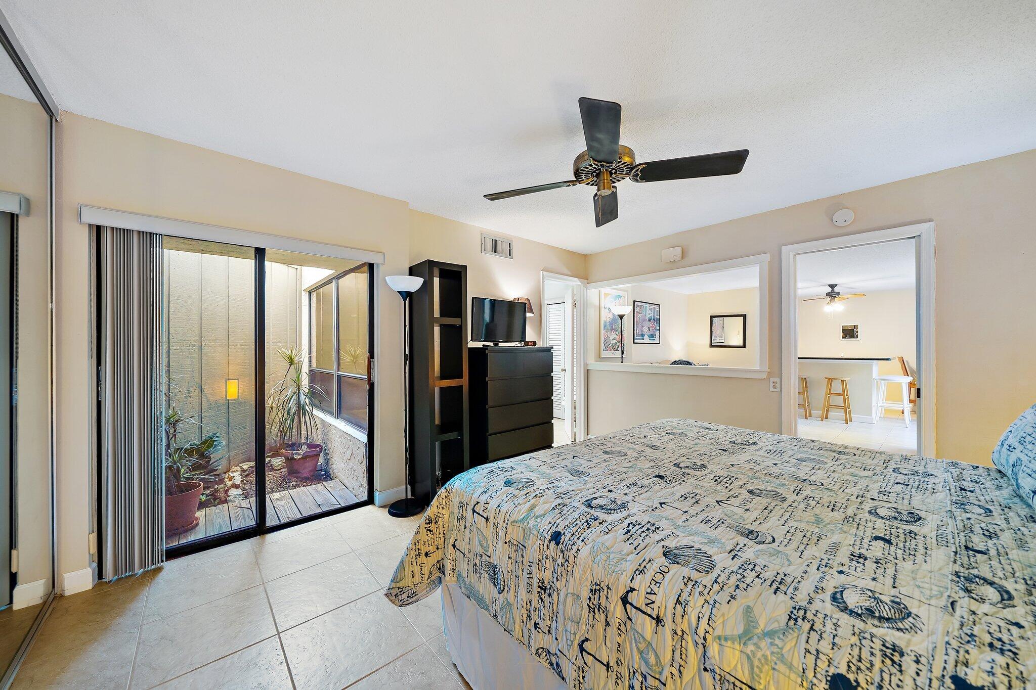 1605 Highway 1, Unit SL5A Jupiter, FL 33477 - Photo 17 of 26 a spacious bedroom with a large bed and a dresser