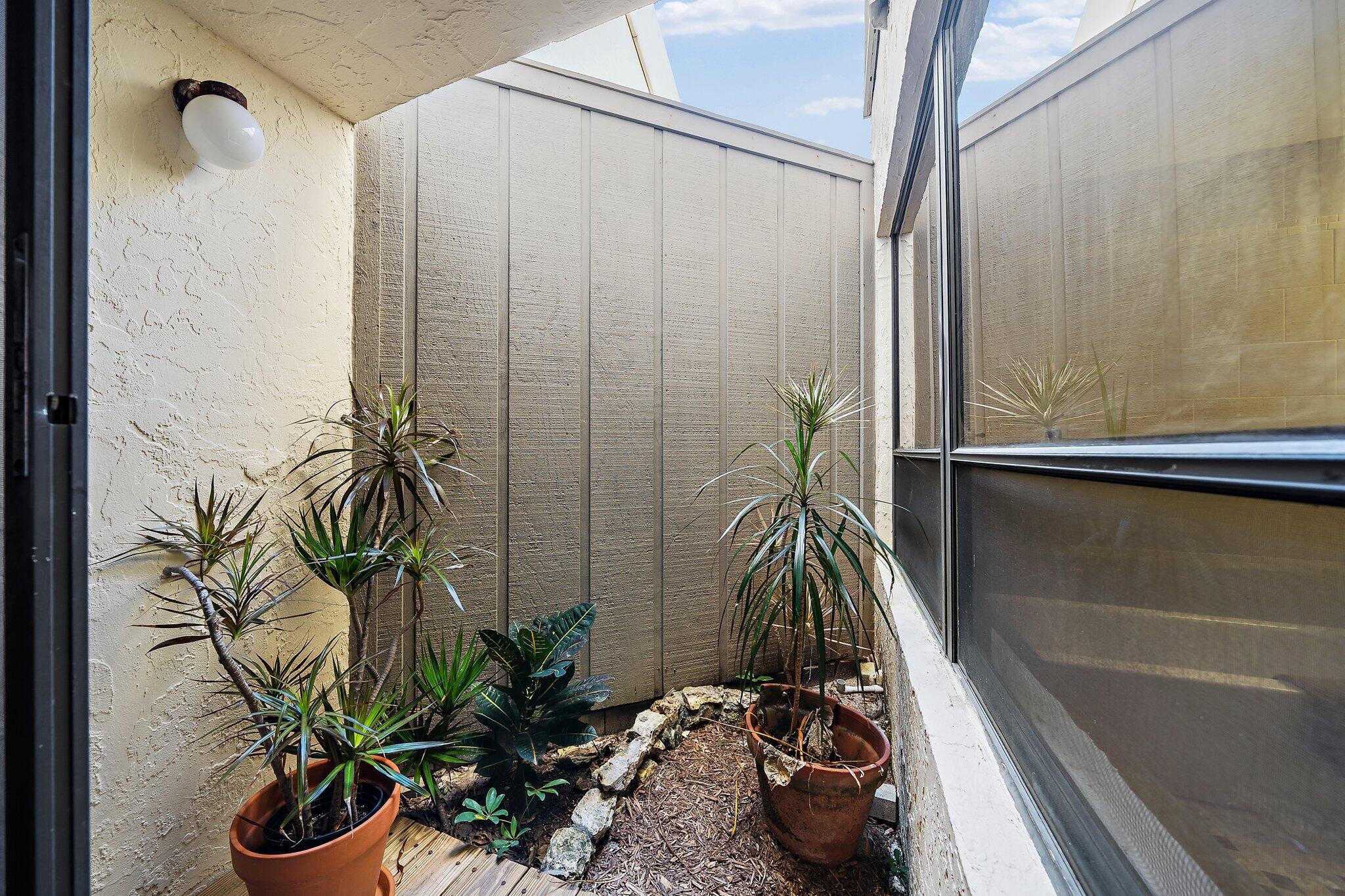 1605 Highway 1, Unit SL5A Jupiter, FL 33477 - Photo 18 of 26 a view of a potted plant next to a window