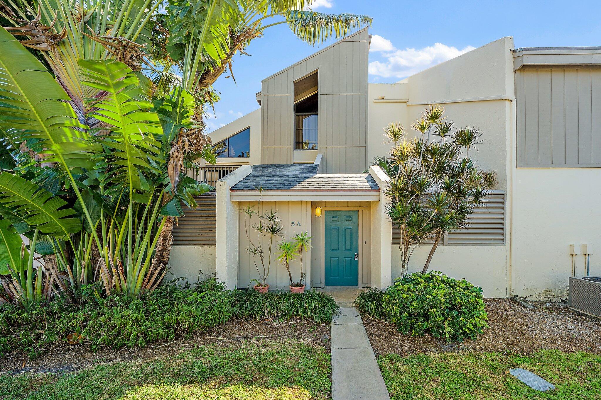 1605 Highway 1, Unit SL5A Jupiter, FL 33477 - Photo 5 of 26 a front view of a house with garden