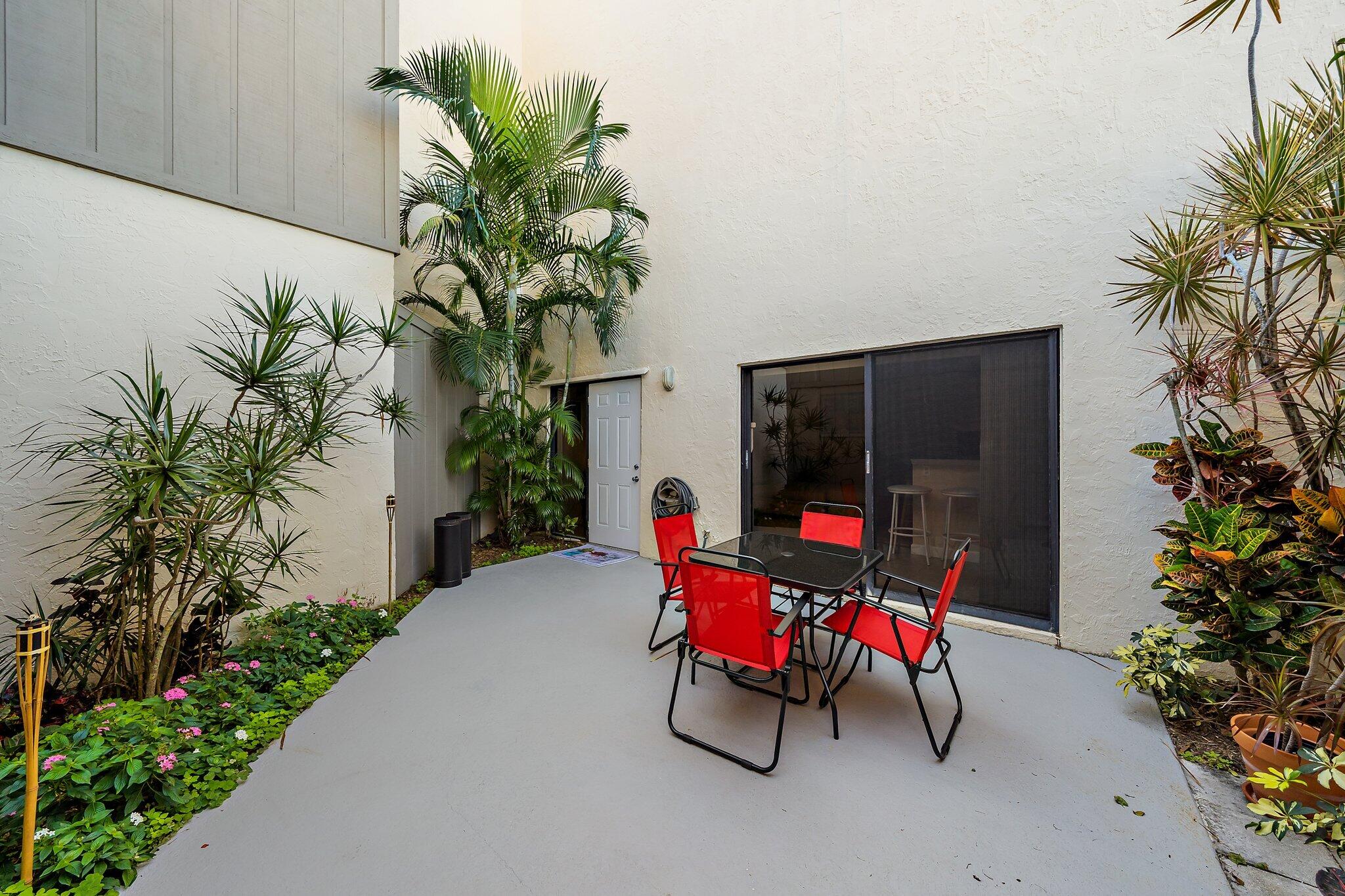 1605 Highway 1, Unit SL5A Jupiter, FL 33477 - Photo 6 of 26 a living room with furniture and flowers