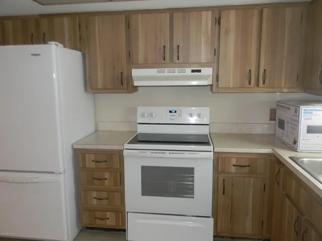 a kitchen with a stove and a refrigerator