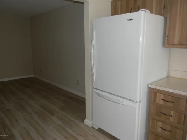 a white refrigerator freezer sitting in a kitchen