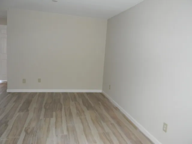a view of an empty room and wooden floor
