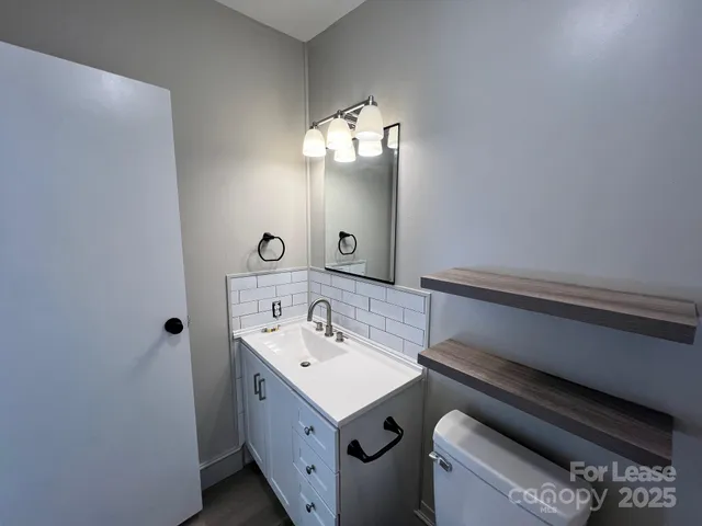 a bathroom with a sink mirror and vanity