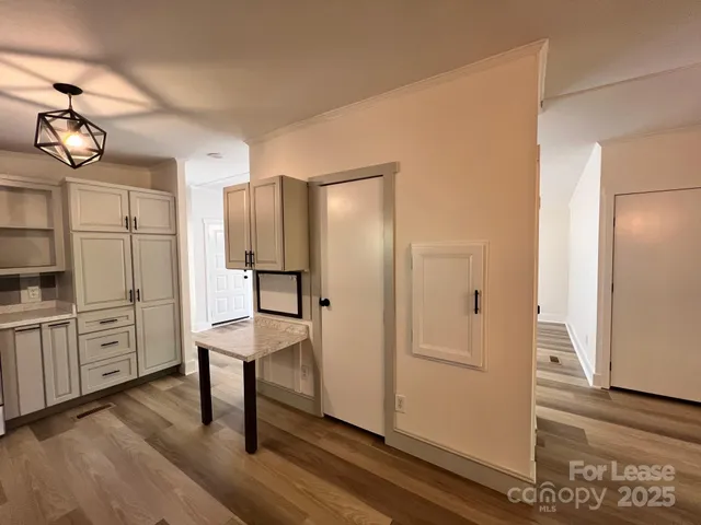 a kitchen with refrigerator cabinets and window
