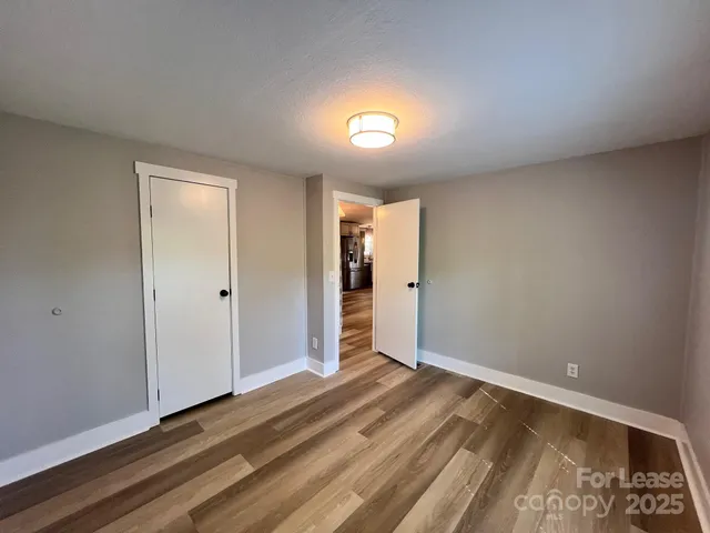 a view of wooden floor and windows in a room