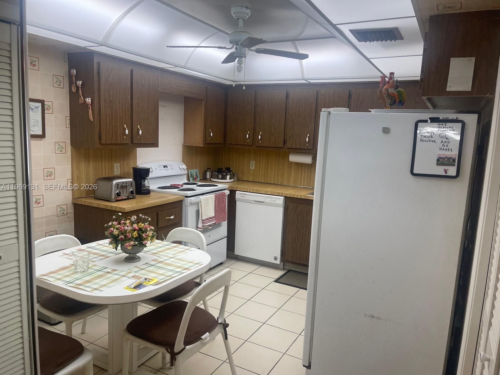16500 Golf Club Road, Unit 204 Weston, FL 33326 - Photo 12 of 26 a kitchen with a sink a stove a refrigerator and island