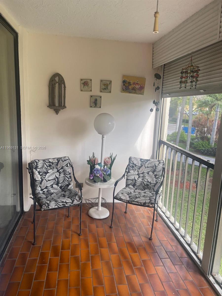 16500 Golf Club Road, Unit 204 Weston, FL 33326 - Photo 18 of 26 a living room with furniture and a floor to ceiling window
