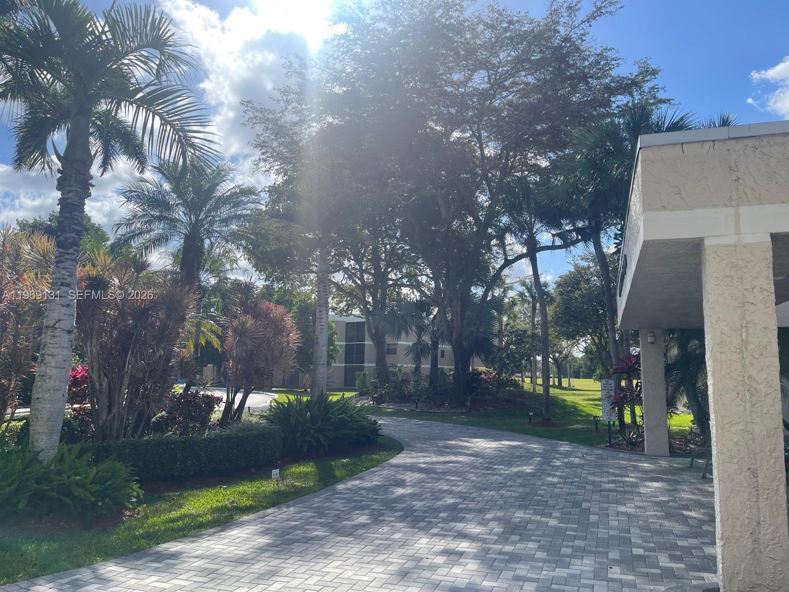 16500 Golf Club Road, Unit 204 Weston, FL 33326 - Photo 2 of 26 a view of a park with large trees