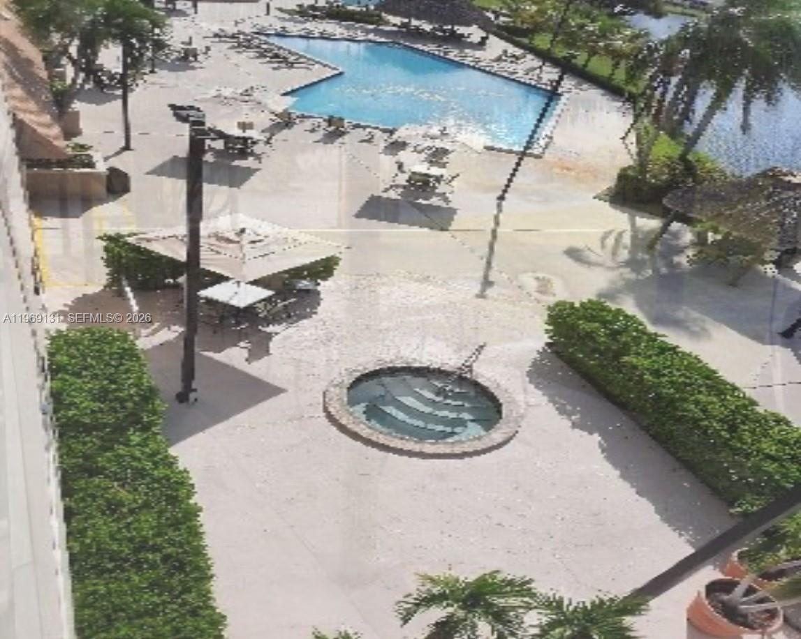 16500 Golf Club Road, Unit 204 Weston, FL 33326 - Photo 21 of 26 a backyard of a house with outdoor seating