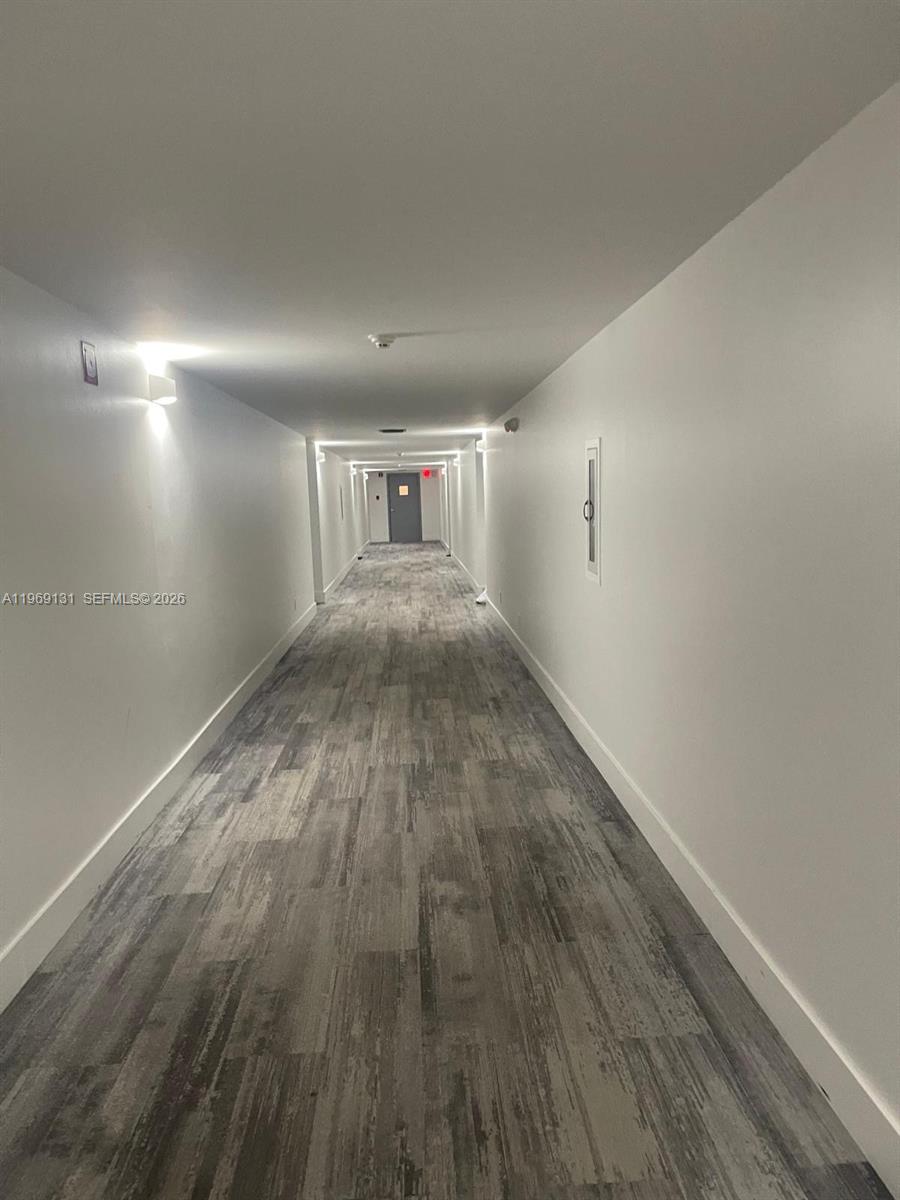 16500 Golf Club Road, Unit 204 Weston, FL 33326 - Photo 4 of 26 an empty room with wooden floor and windows