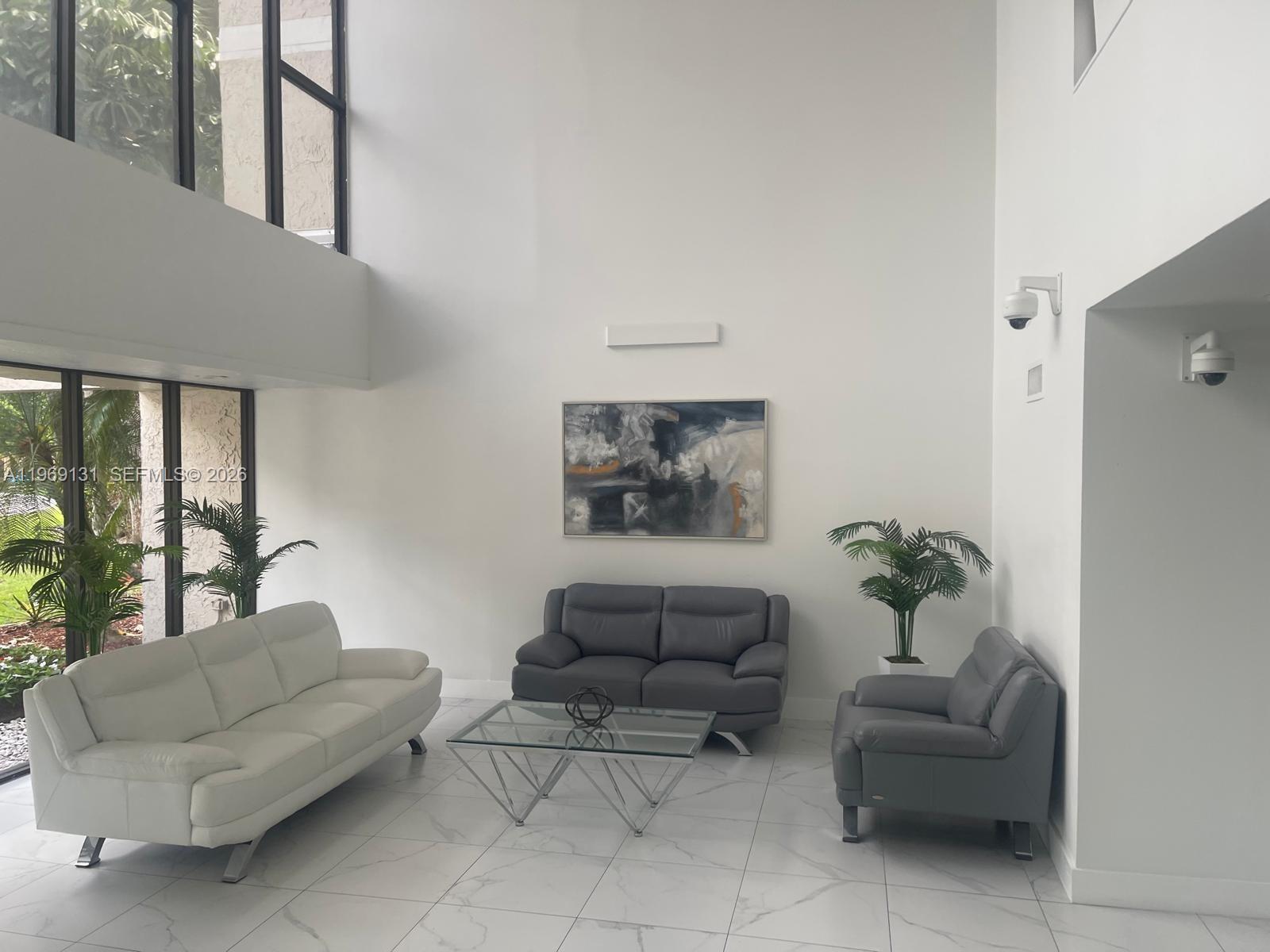 16500 Golf Club Road, Unit 204 Weston, FL 33326 - Photo 5 of 26 a living room with furniture and a potted plant