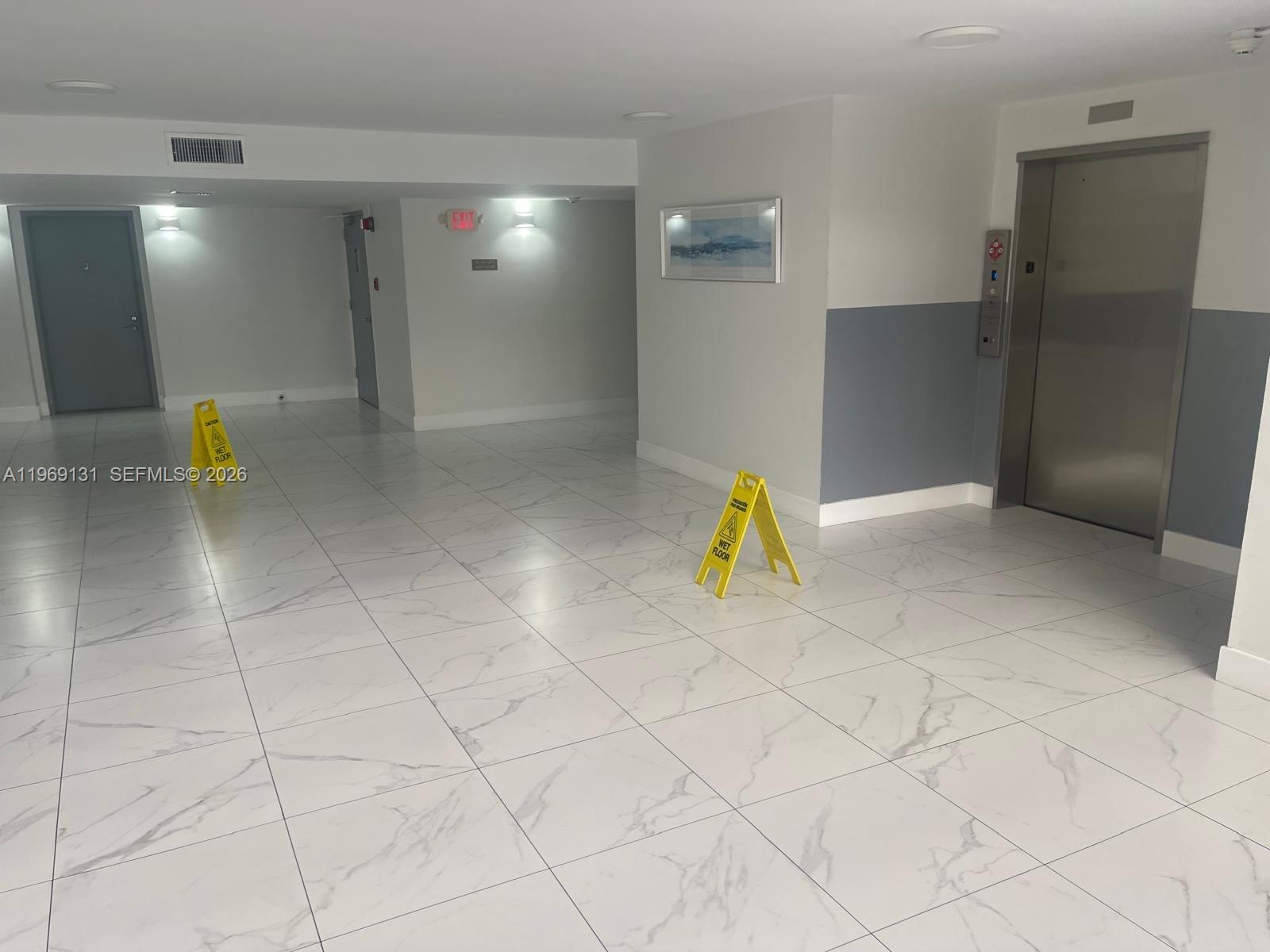 16500 Golf Club Road, Unit 204 Weston, FL 33326 - Photo 7 of 26 a view of a livingroom with a chair and chandelier