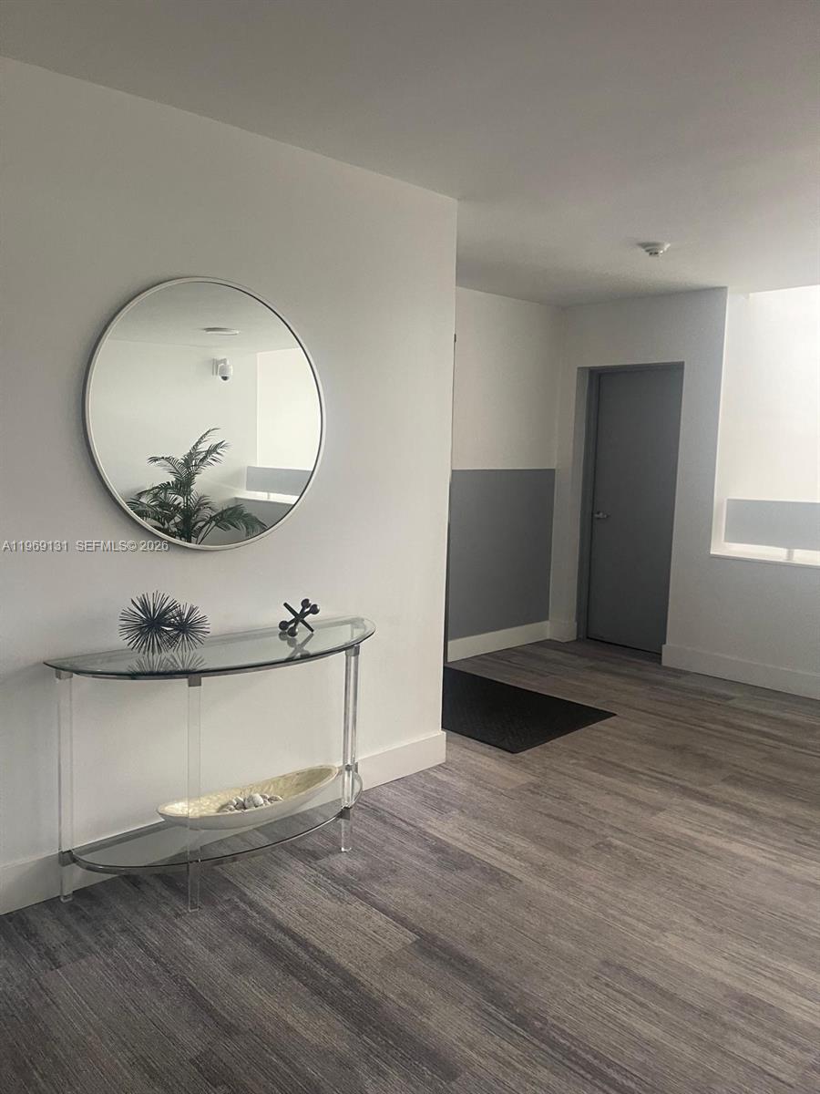 16500 Golf Club Road, Unit 204 Weston, FL 33326 - Photo 8 of 26 a view of a room with wooden floor and mirror