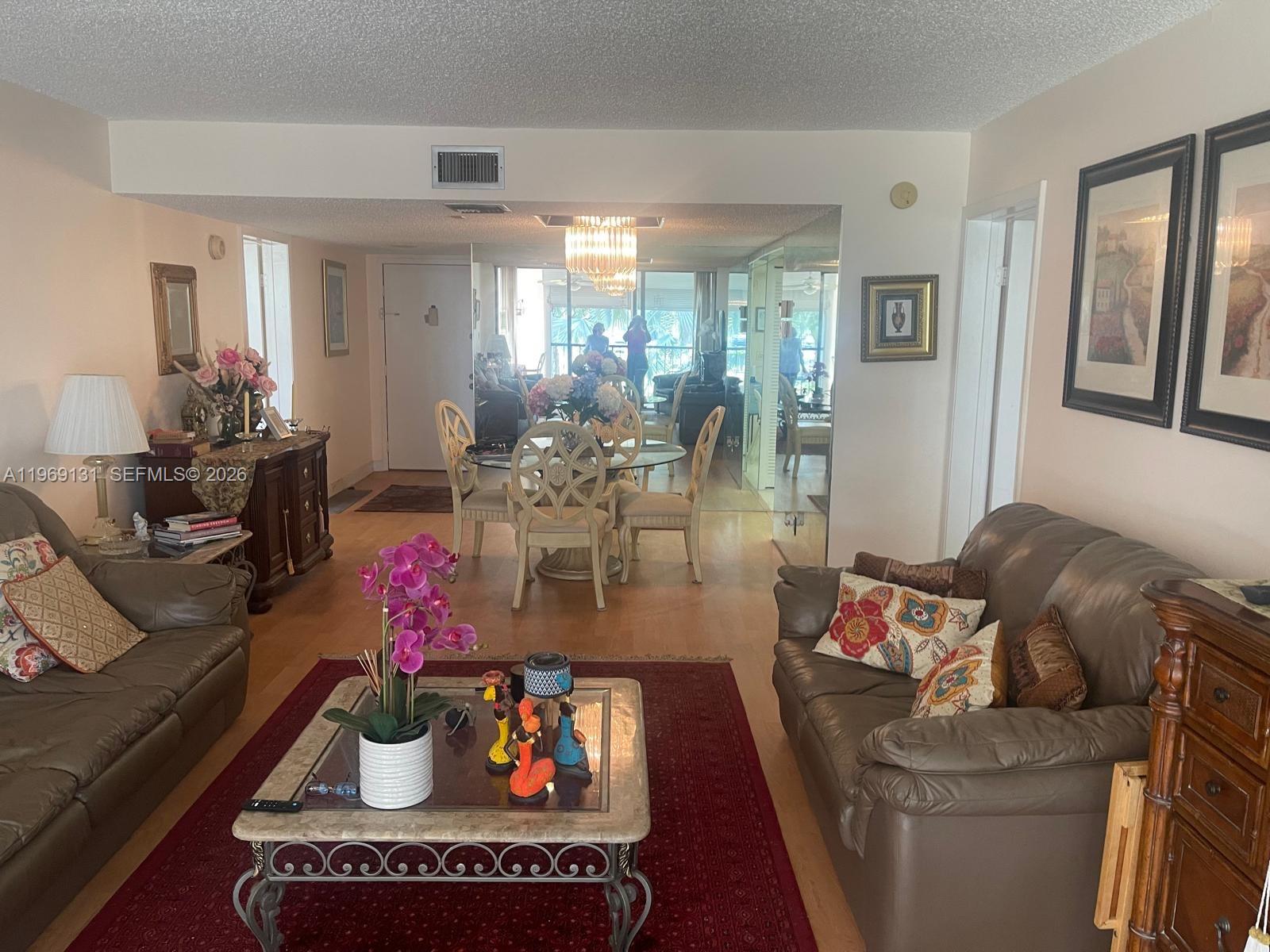 16500 Golf Club Road, Unit 204 Weston, FL 33326 - Photo 9 of 26 a living room with furniture and flowers