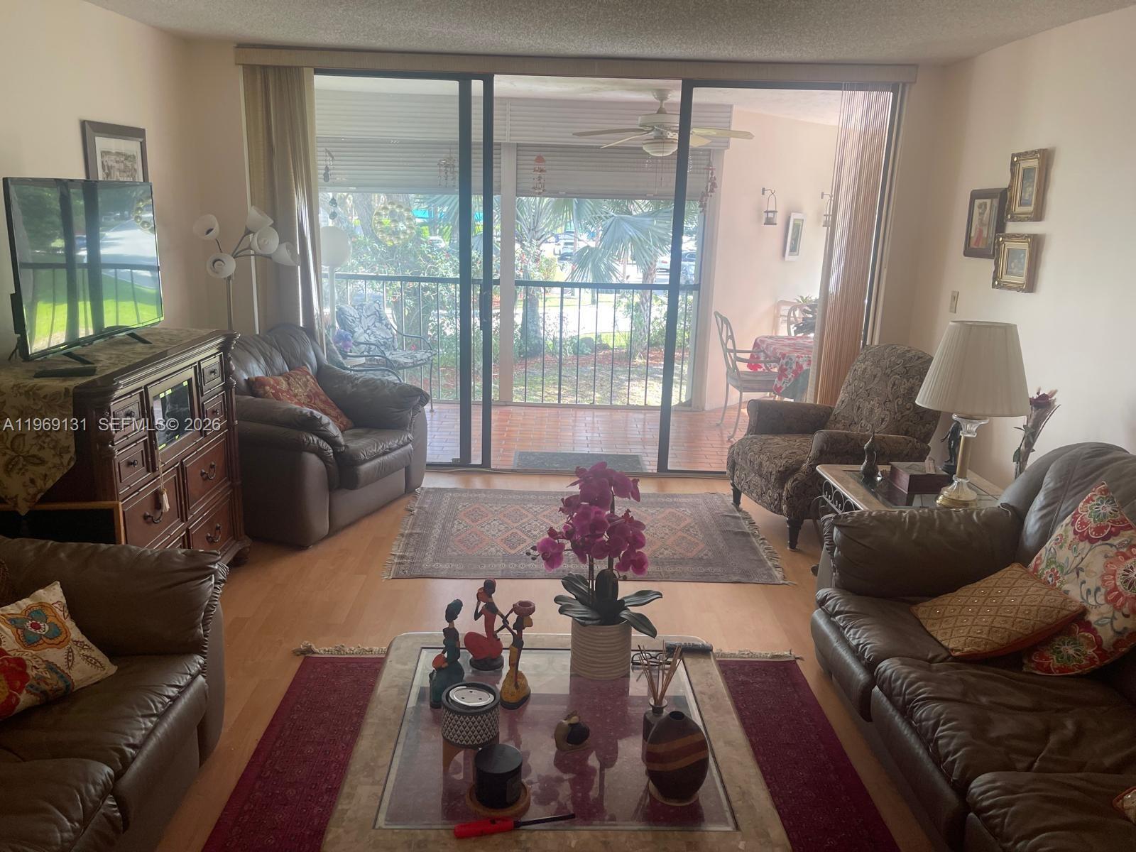 16500 Golf Club Road, Unit 204 Weston, FL 33326 - Photo 10 of 26 a living room with furniture and a large window