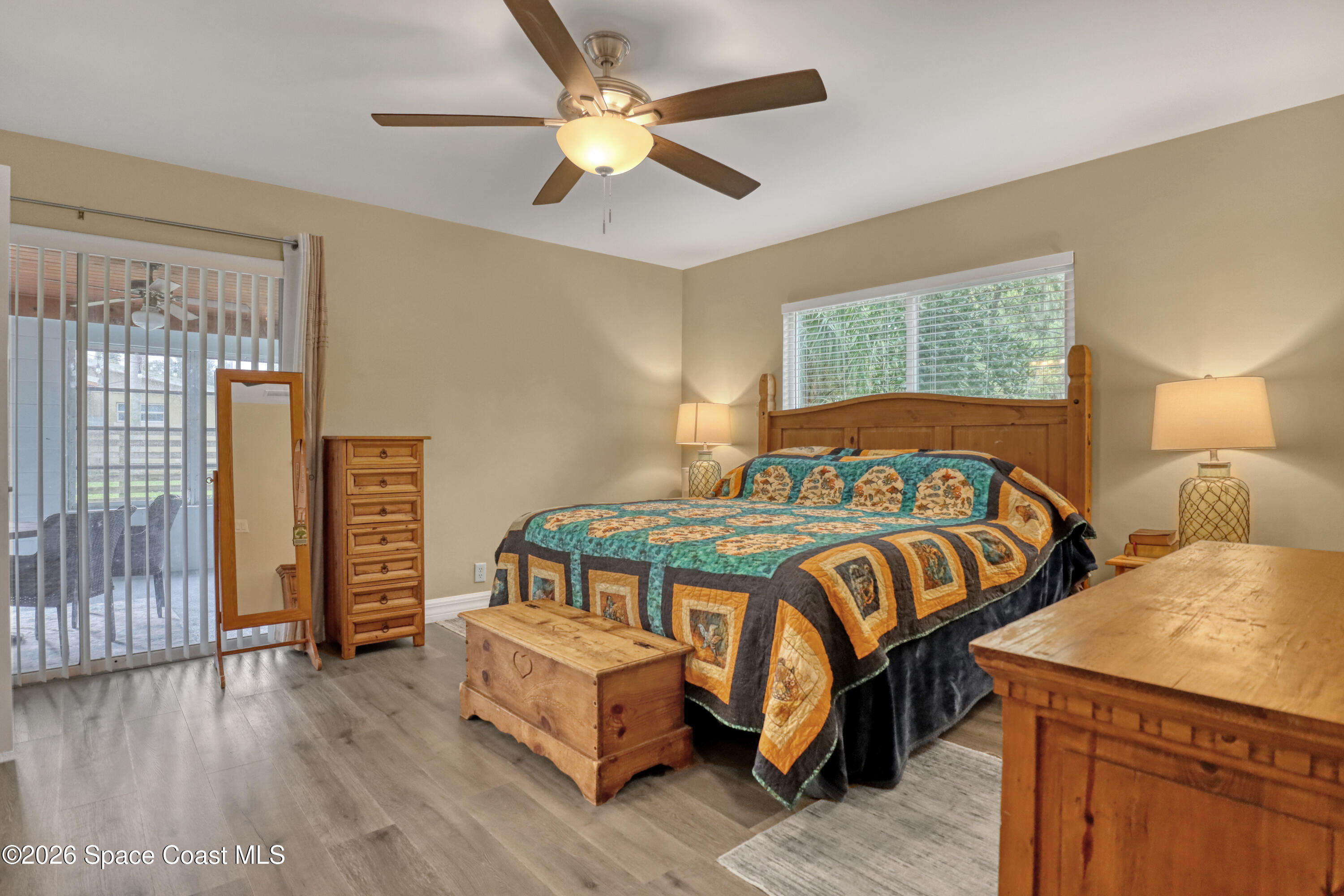 2307 Country Club Road Melbourne, FL 32901 - Photo 14 of 44 a bedroom with a bed a chandelier and next to a window