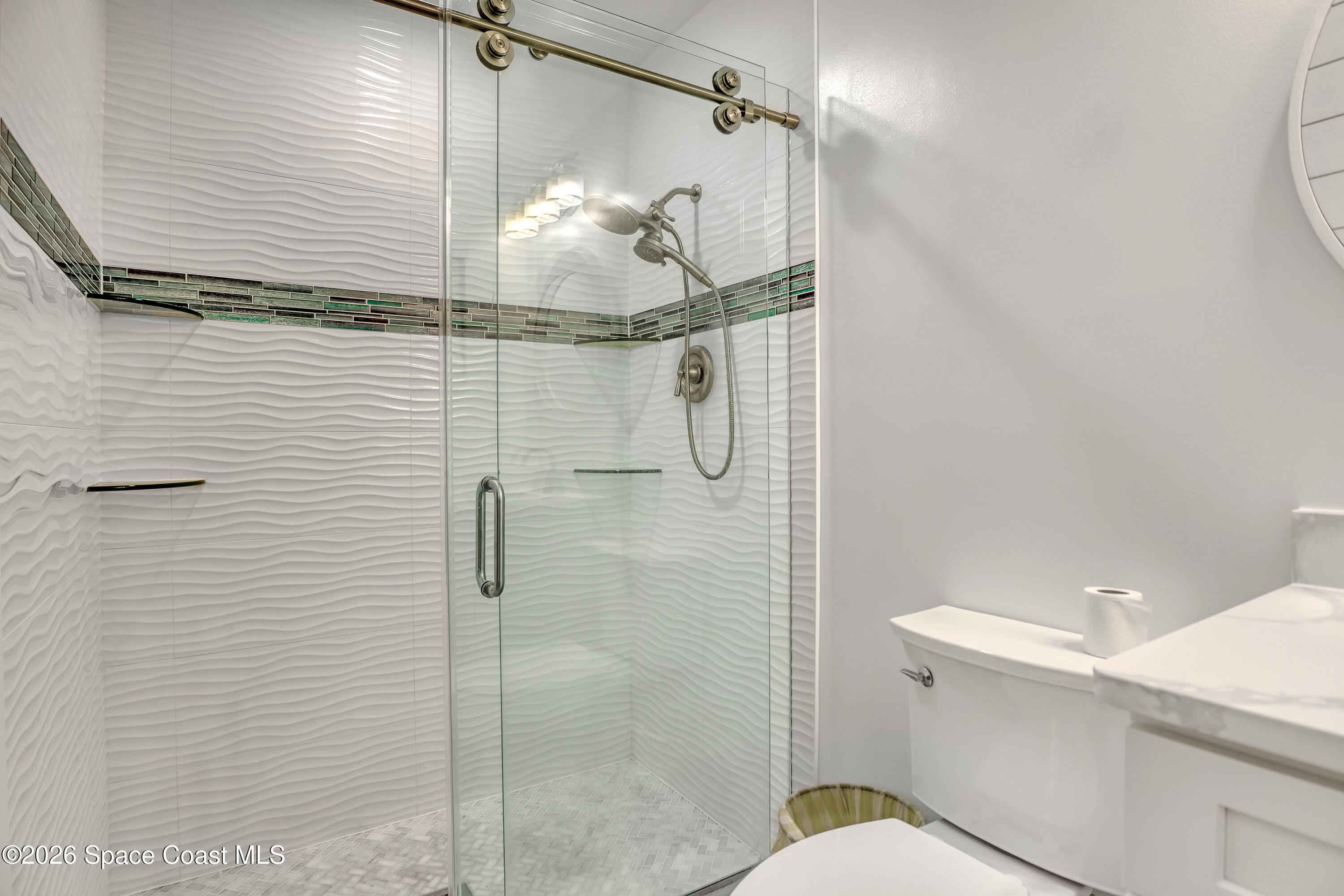 2307 Country Club Road Melbourne, FL 32901 - Photo 17 of 44 a bathroom with a shower and toilet