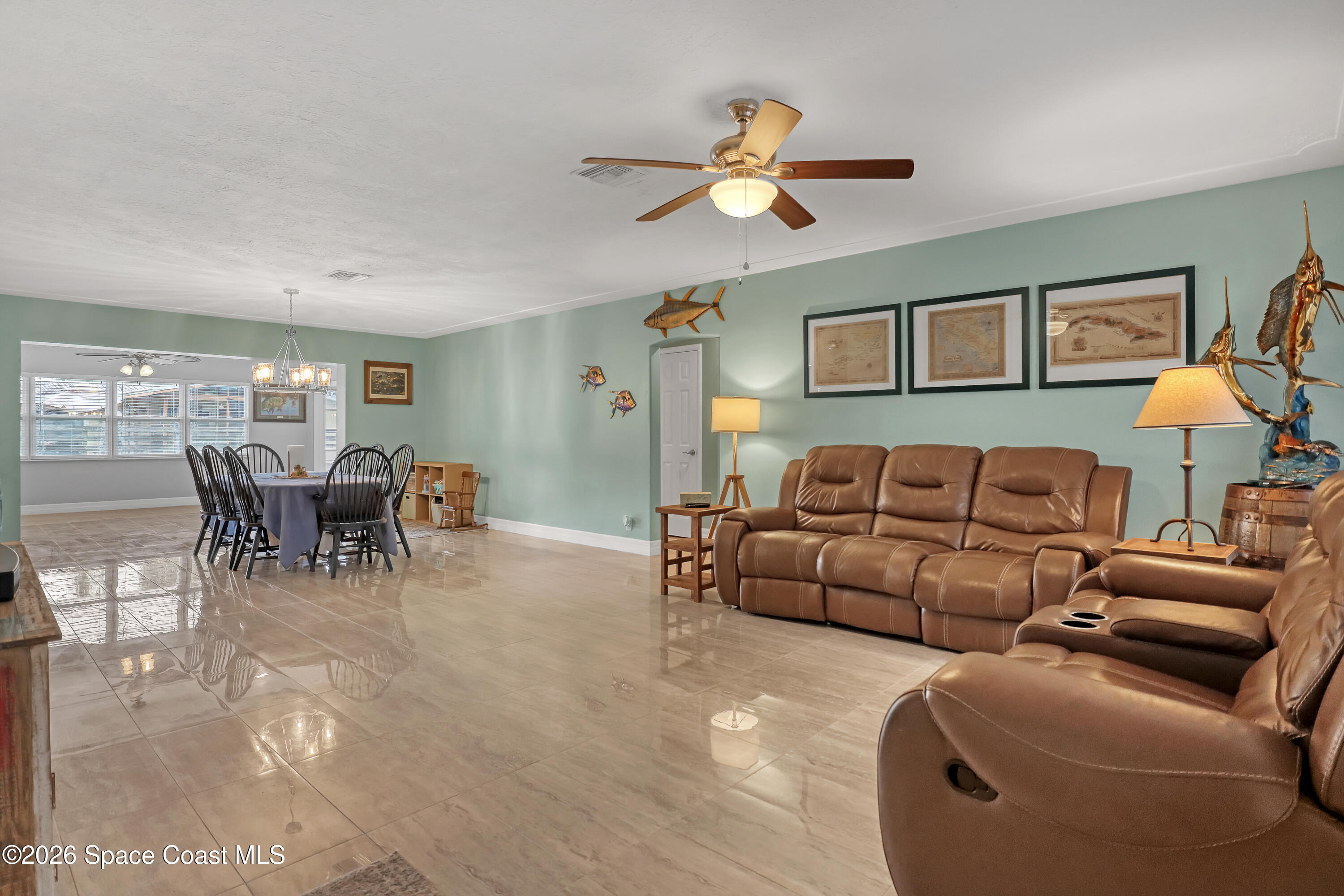 2307 Country Club Road Melbourne, FL 32901 - Photo 2 of 44 a living room with furniture and a dining table with kitchen view