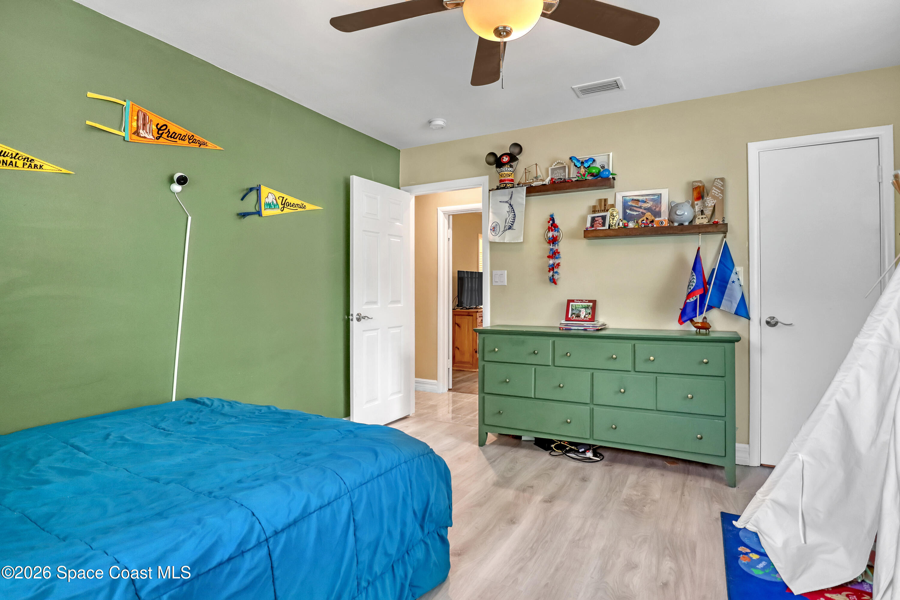 2307 Country Club Road Melbourne, FL 32901 - Photo 22 of 44 a bedroom with a bed and a dresser