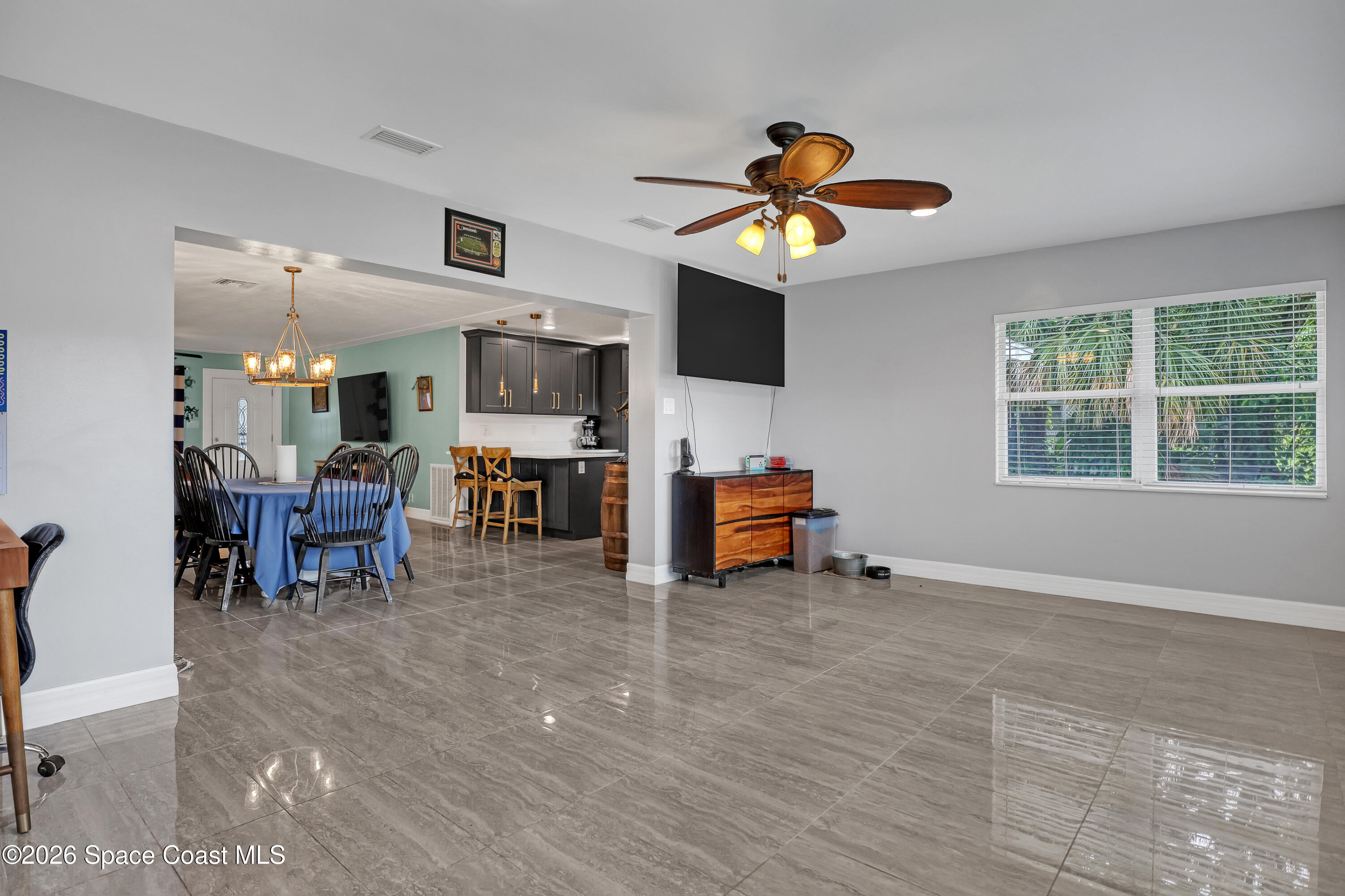 2307 Country Club Road Melbourne, FL 32901 - Photo 26 of 44 a living room with furniture and a flat screen tv