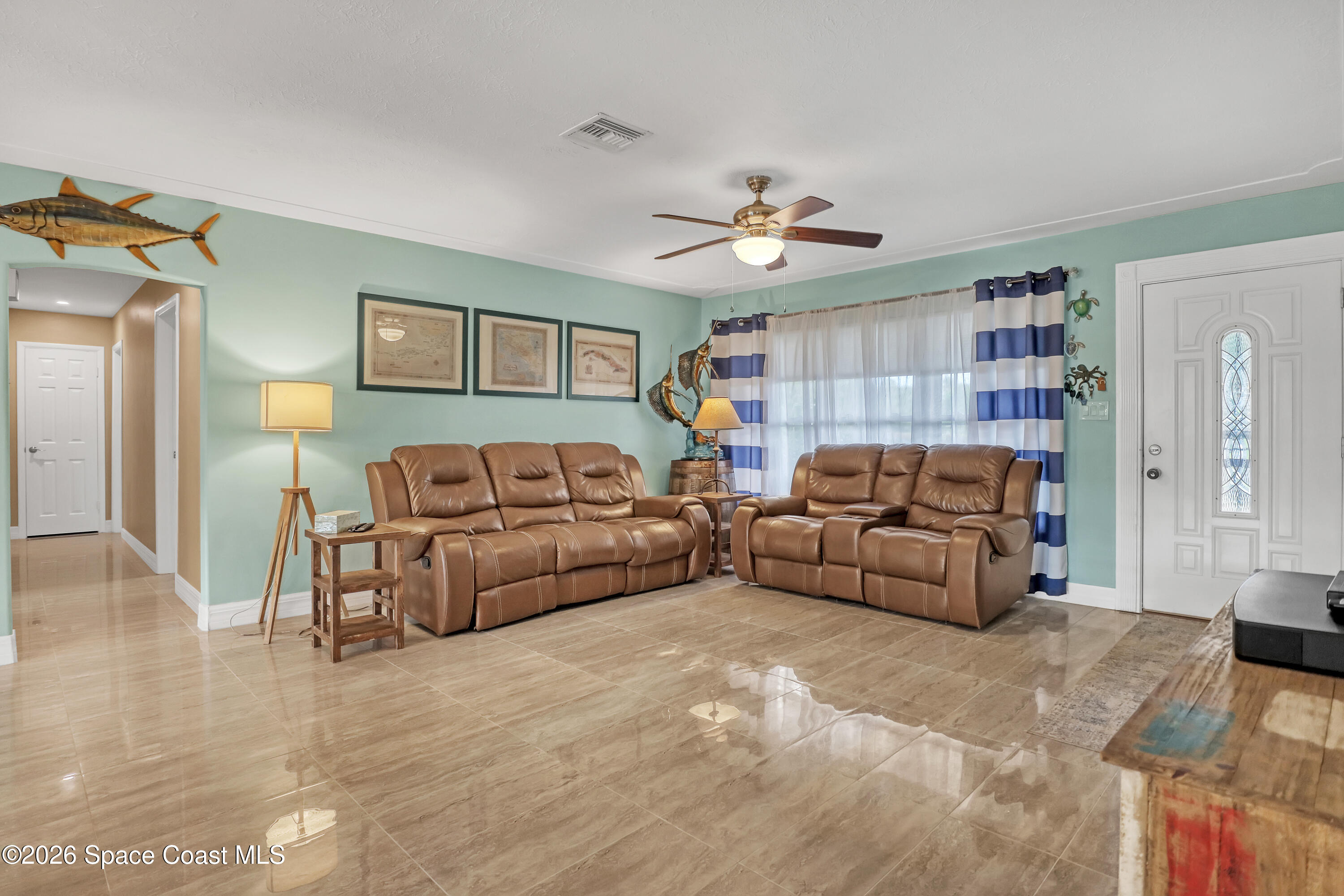 2307 Country Club Road Melbourne, FL 32901 - Photo 3 of 44 a living room with furniture and a ceiling fan