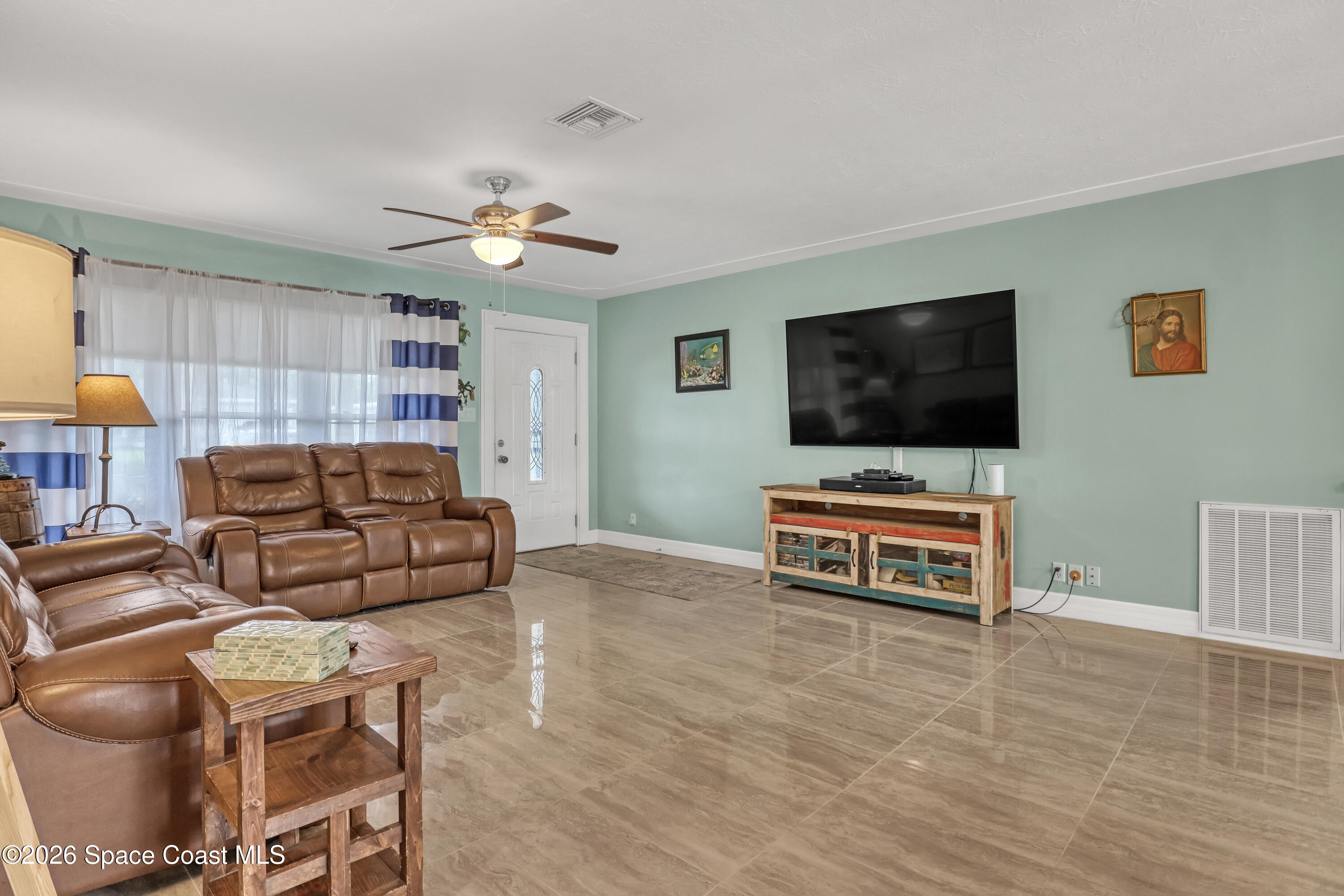 2307 Country Club Road Melbourne, FL 32901 - Photo 4 of 44 a living room with furniture and a flat screen tv