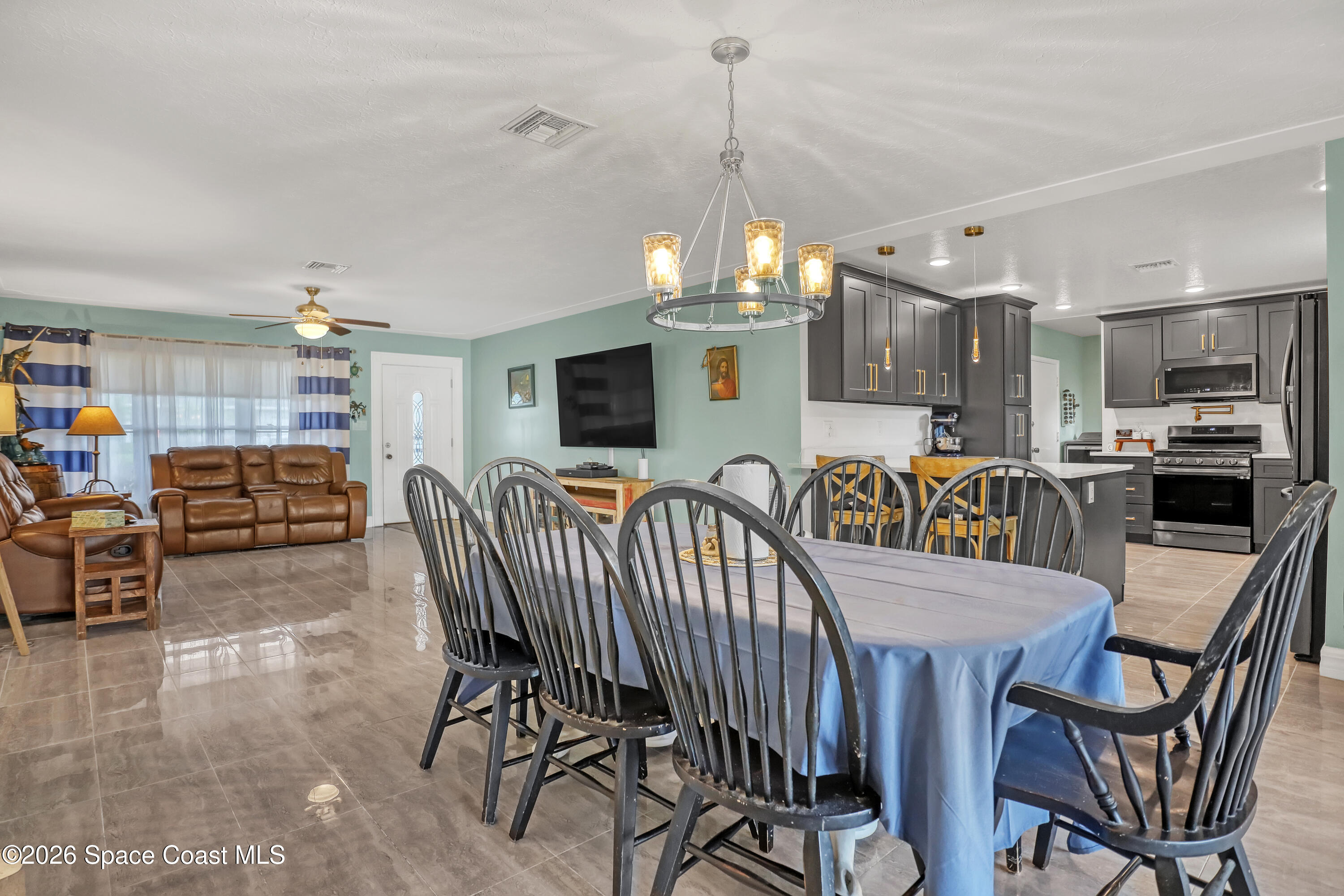 2307 Country Club Road Melbourne, FL 32901 - Photo 7 of 44 a dining room with furniture and chandelier
