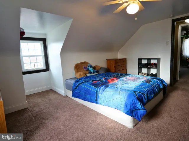 a bedroom with bed and a chandelier