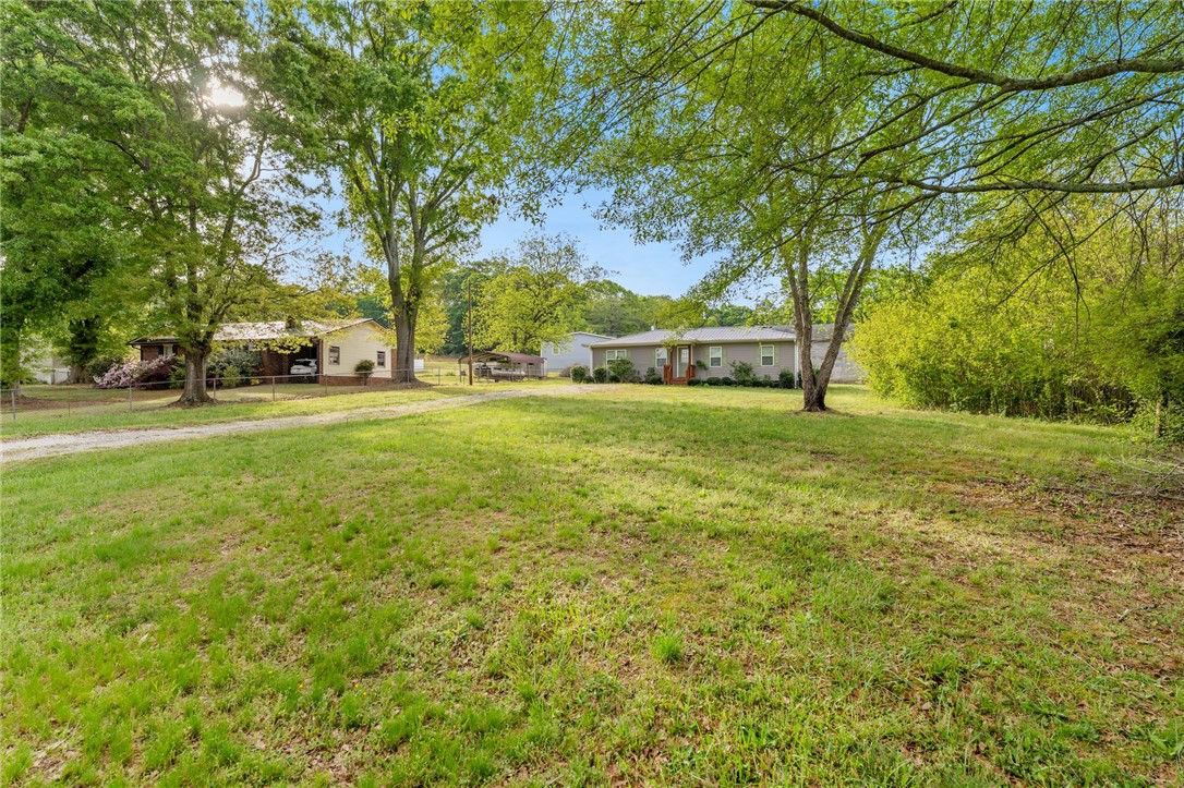 104 Leah Drive Pendleton, SC 29670 - Photo 3 of 23 Expansive green lawn offers a refreshing view of charming residences set amongst mature trees.