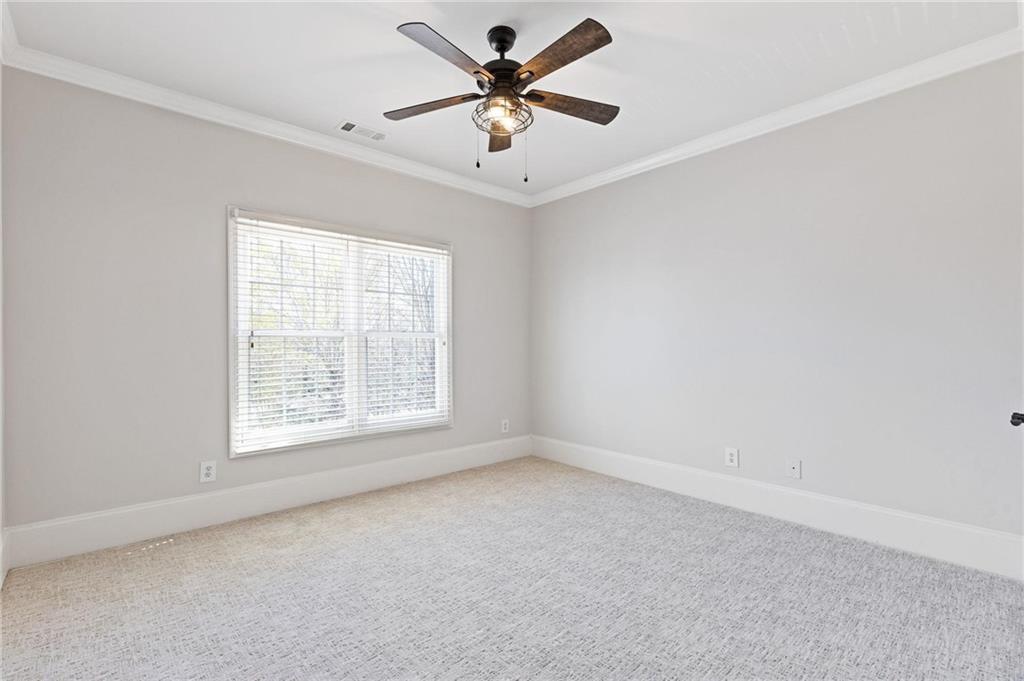 2010 Legends Way Braselton, GA 30517 - Photo 36 of 77 an empty room with windows and ceiling fan