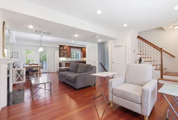 a living room with furniture and wooden floor