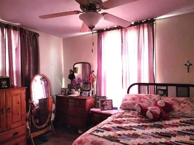 a bedroom with a bed and a chandelier