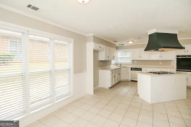 a kitchen with a stove a sink and a refrigerator