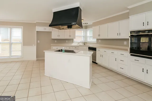 a kitchen with stainless steel appliances a stove a microwave and cabinets