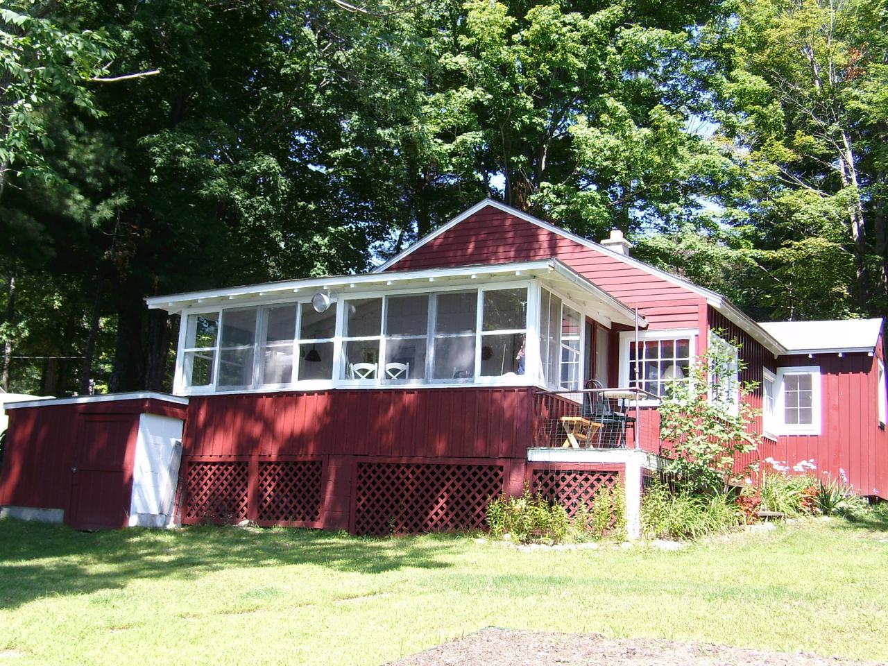 156 Kibbe Road Otis, MA 01029 - Photo 1 of 6 a front view of a house with a yard table and chairs