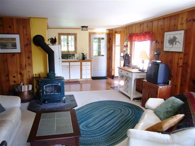 156 Kibbe Road Otis, MA 01029 - Photo 5 of 6 a living room with furniture fireplace and a large window