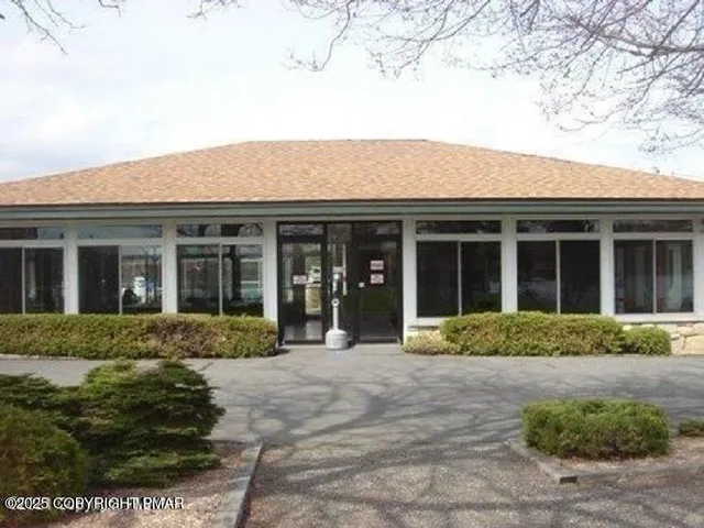 front view of a brick house with a yard