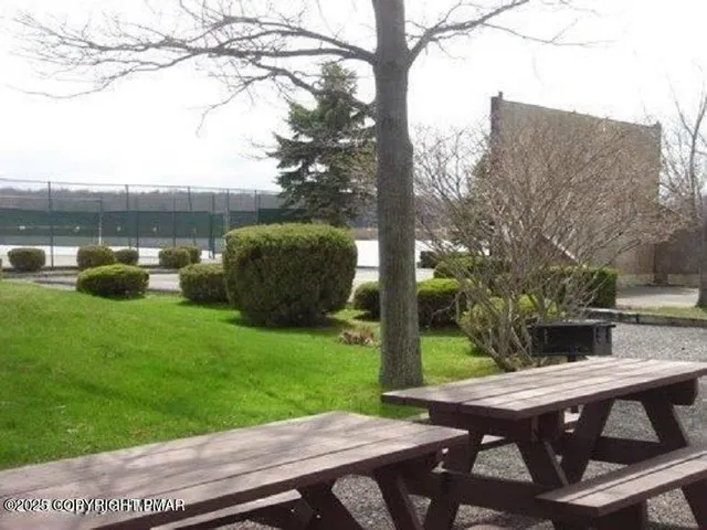 a view of backyard with seating area and green space