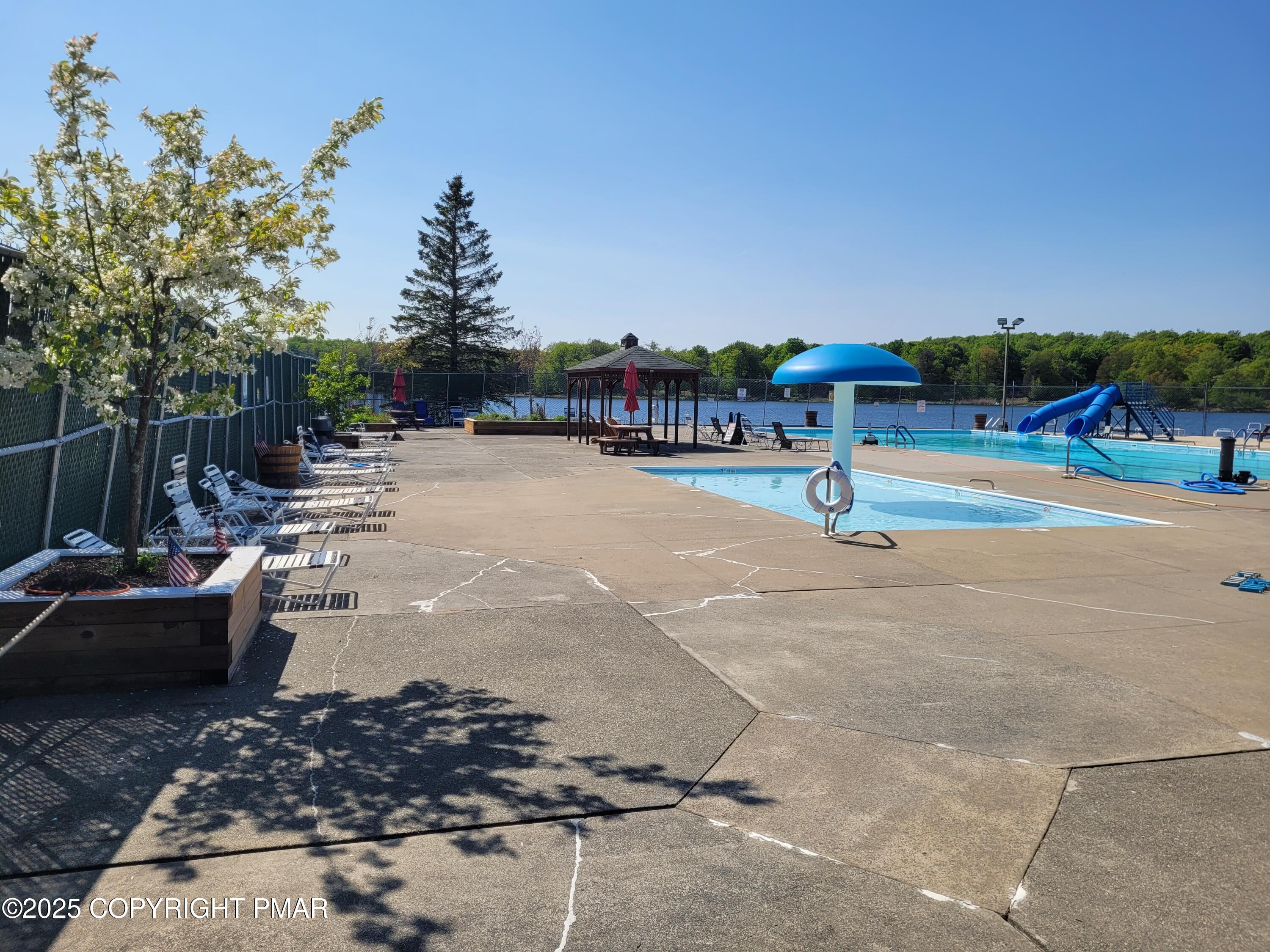 51 Middle Ridge Drive Newfoundland, PA 18445 - Photo 9 of 33 a swimming pool with outdoor seating and barbeque oven