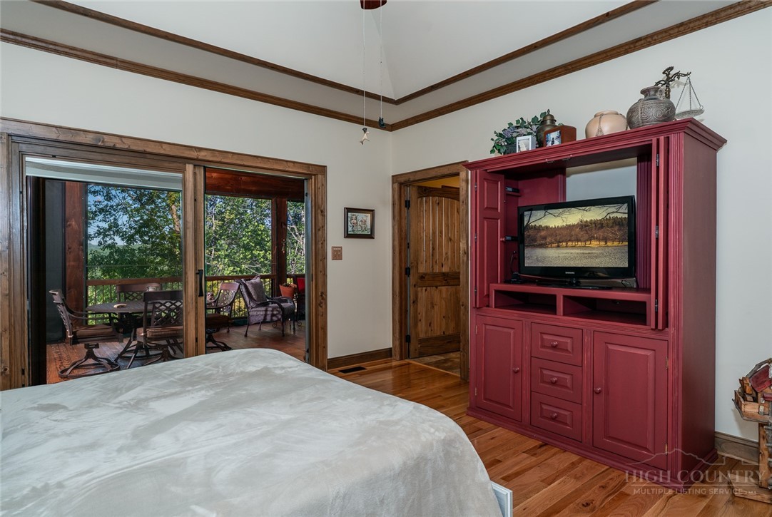 171 Camp Davis Road Banner Elk, NC 28604 - Photo 20 of 48 a bedroom with a bed and a flat screen tv