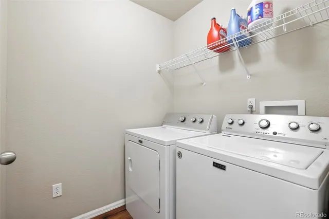 a view of a house with a wooden fence